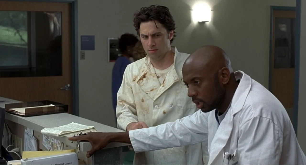 Mi Perfecto Ex (2024) movie still: medium — A hospital nurses station features a grey laminate counter and beige walls. Two male doctors stand…