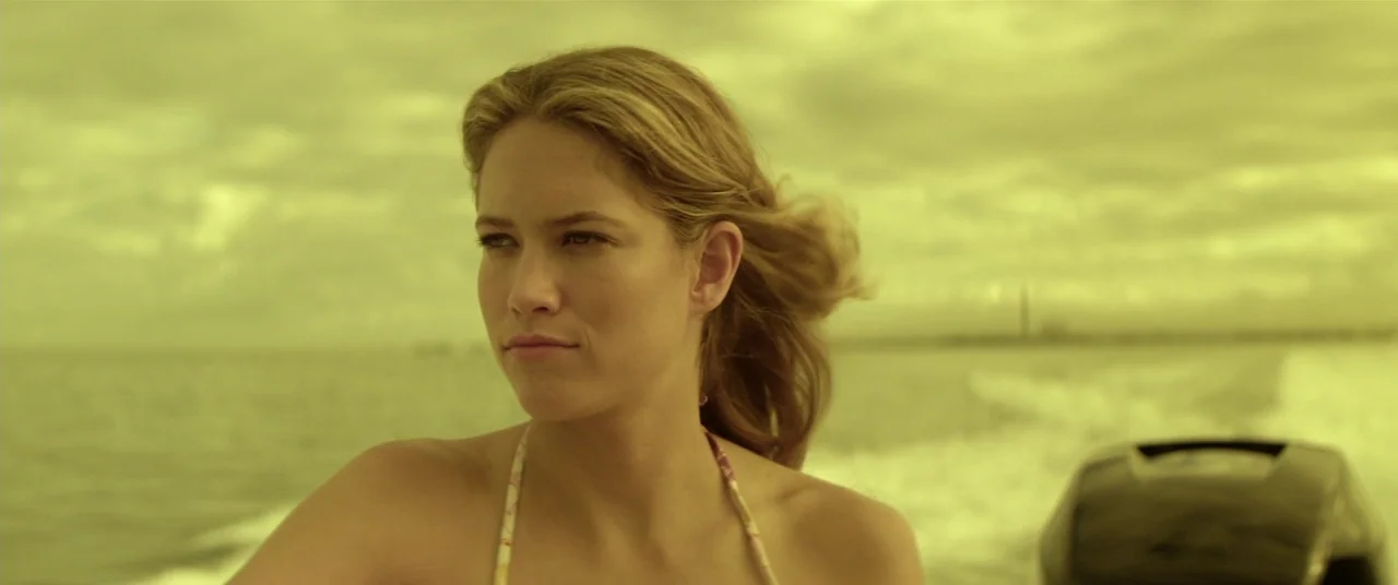 Magic Mike (2012) movie still: medium — A person rides on a small boat across an expanse of open water. The woman looks away from the camera as the…