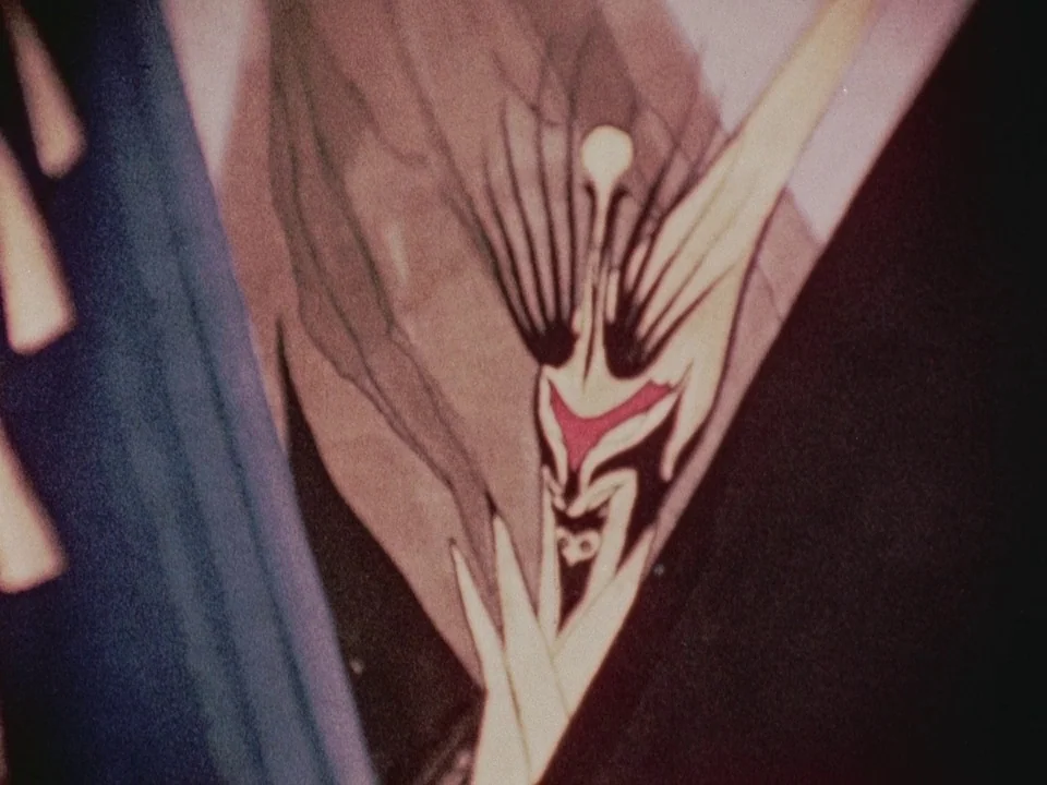 The Wormwood Star (1956) movie still: closeup — An abstract illustration shows an ornate, symmetrical icon with a triangular red center piece.…