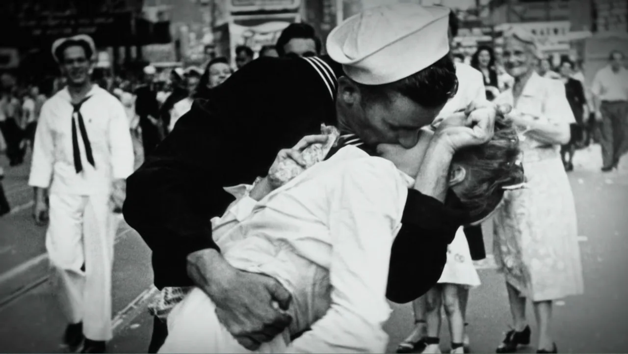 Wartorn: 1861-2010 (2010) movie still: medium — A crowded public city street filled with pedestrians celebrating after the second world war. A…