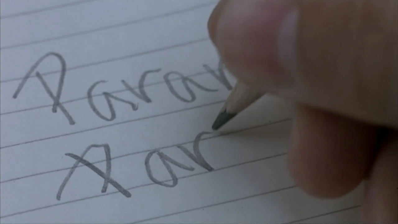 Paranoid Park (2007) movie still: closeup — A sheet of white lined notebook paper fills the frame. A wooden pencil writes handwritten letters on the…