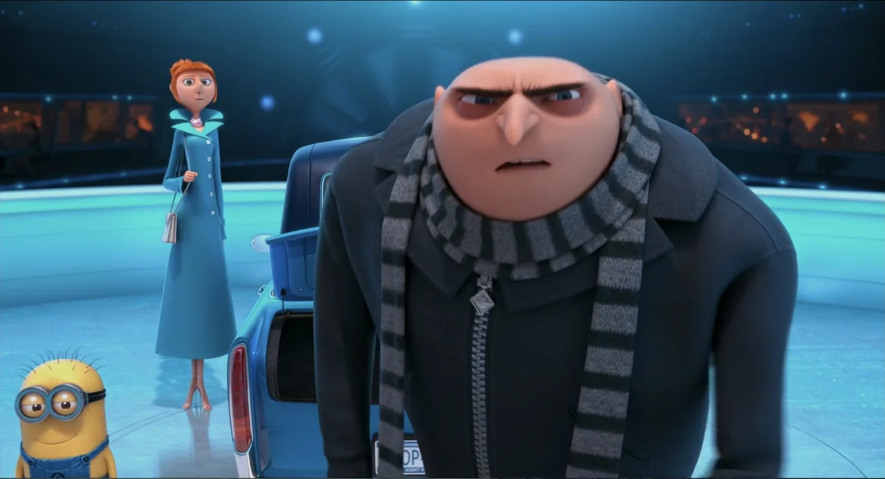 Despicable Me 2 (2013) movie still: medium — A spacious, illuminated room features curved blue walls and a central blue sports car. A man in a…