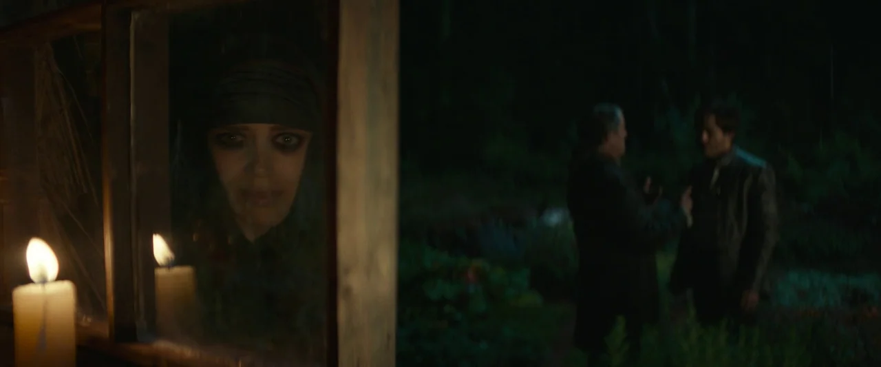 Dungeons & Dragons: Honor Among Thieves (2023) movie still: medium — A woman stares from behind a window with a burning candle in the foreground.…