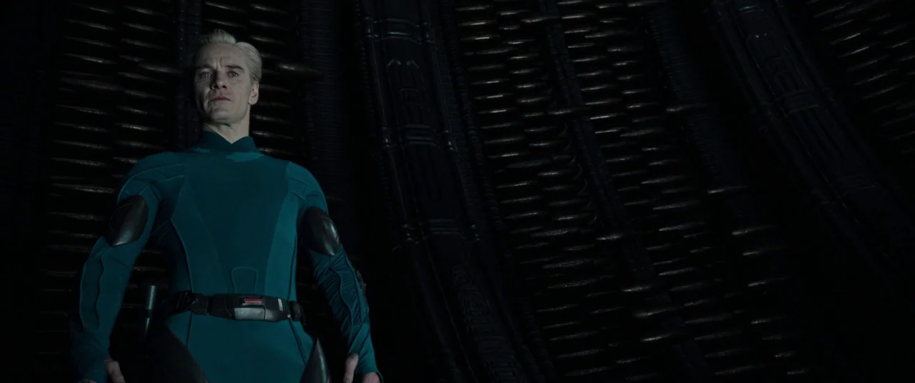 Alien: Covenant (2017) movie still: medium — A dark, alien-designed interior features wall panels with vertical ridges and repeating mechanical…