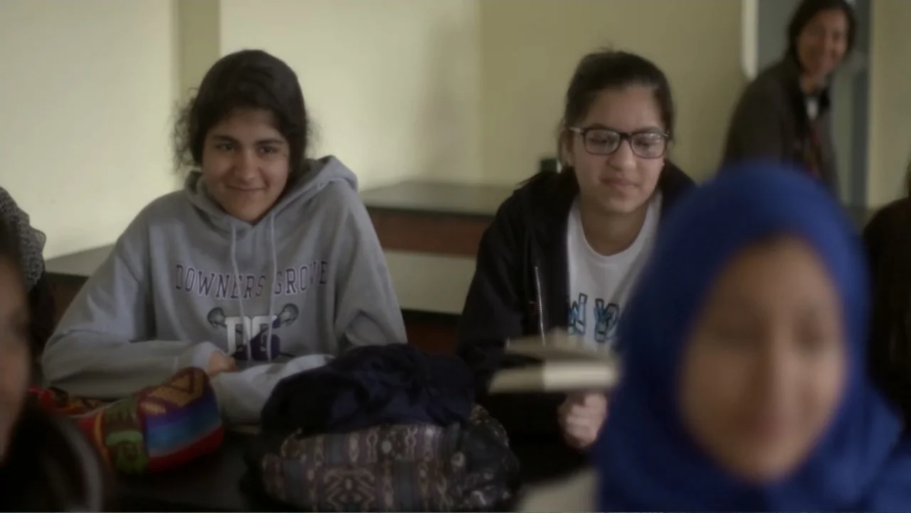 Homegrown: The Counter-Terror Dilemma (2016) movie still: medium — A quiet classroom interior with students seated at wooden desks in front of…