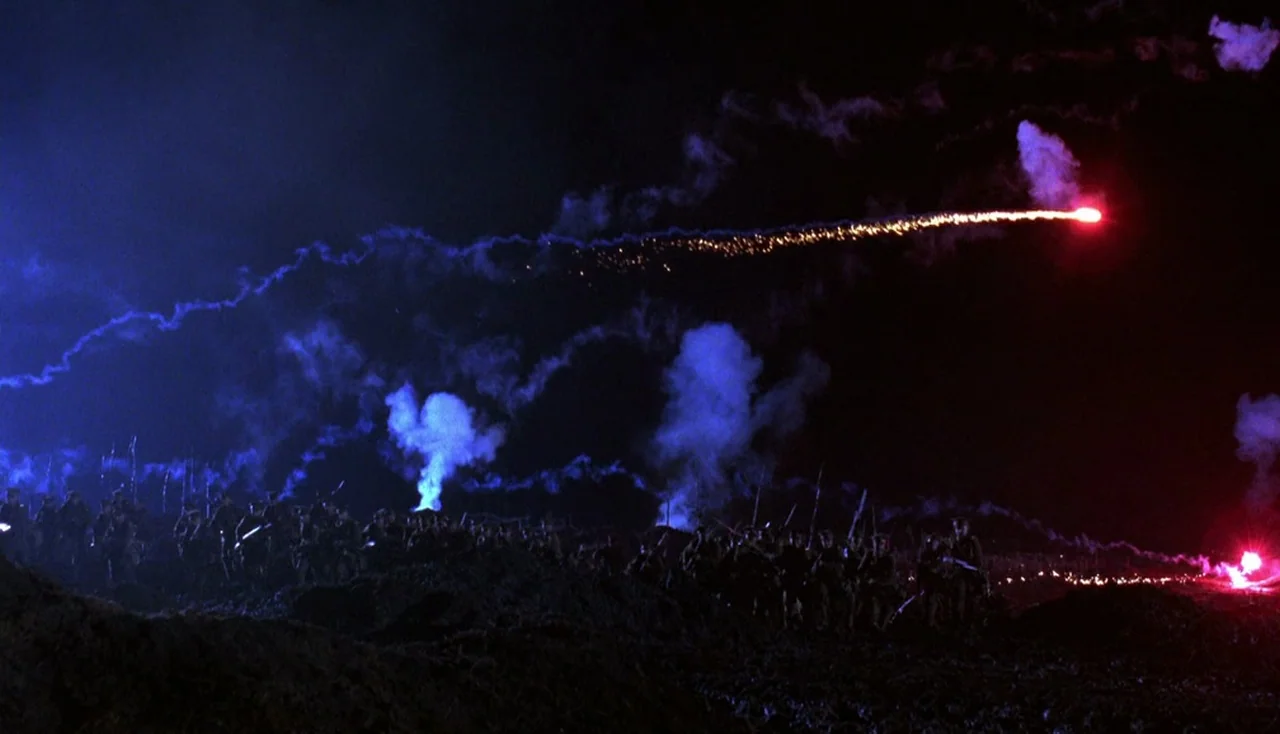 Legends of the Fall (1994) movie still: wide — An expanse of muddy earth under a pitch black night sky filled with glowing tracers. Numerous…