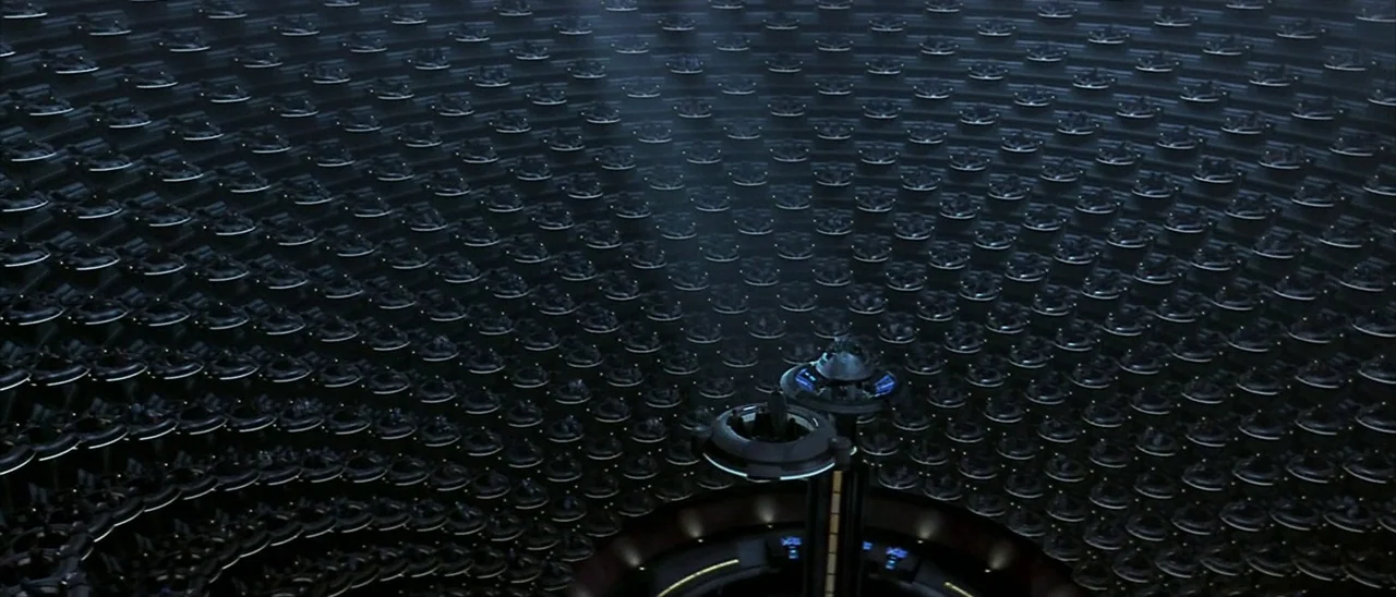 Star Wars: Episode I – The Phantom Menace (1999) movie still: establishing — A vast, cylindrical legislative chamber features concentric rings of…