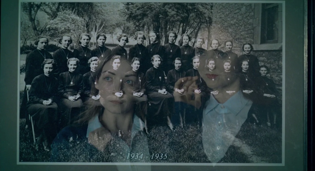 The Moth Diaries (2011) movie still: closeup — A framed black-and-white group photograph of a girls' school class rests under glass. A young woman's…