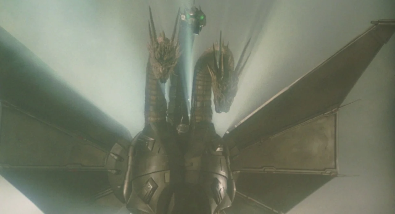 Godzilla vs. King Ghidorah (1991) movie still: medium — A metallic mechanical three-headed dragon hovers in a dense, hazy, light-filled sky. The…