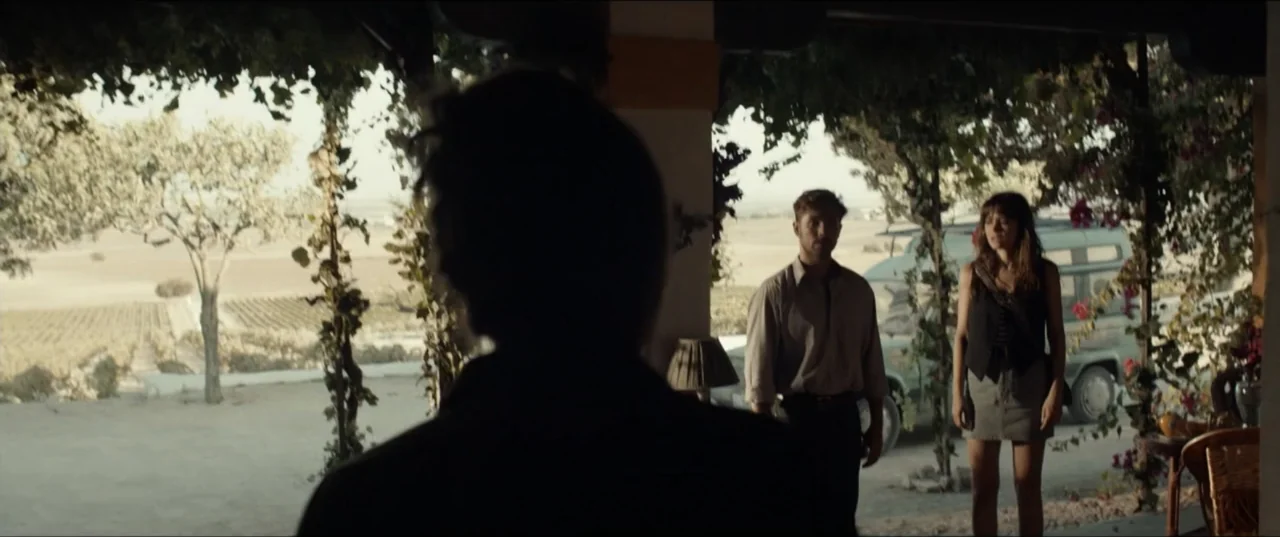 Hear Me: Our Summer (2024) movie still: medium — A sunny veranda with blooming bougainvillea frames a view of a rural landscape. A man and a woman…