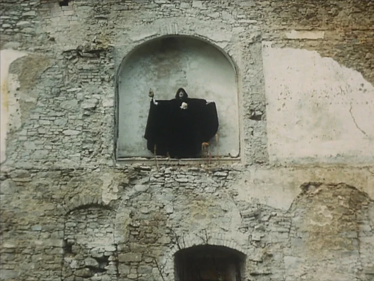 Valerie & Her Week of Wonders (1970) movie still: wide — A weathered stone wall features deep architectural niches and aged, crumbling masonry. A…