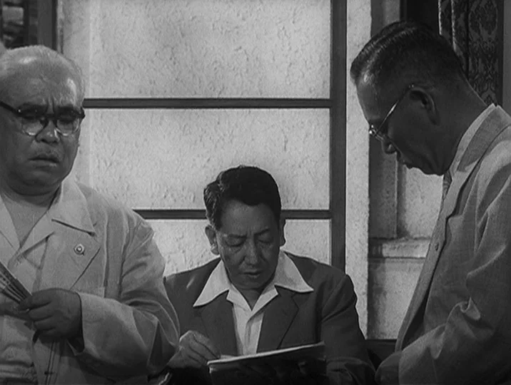 I Live In Fear (1955) movie still: medium — An office interior features three men standing near a grid-paned frosted glass window. They examine…
