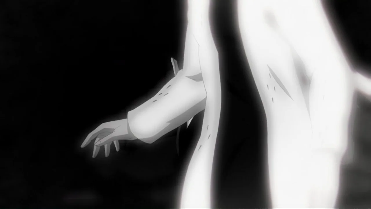 Batman: Year One (2011) movie still: closeup — A dark, featureless void contains a single glowing figure. The person wears a long, light-colored…