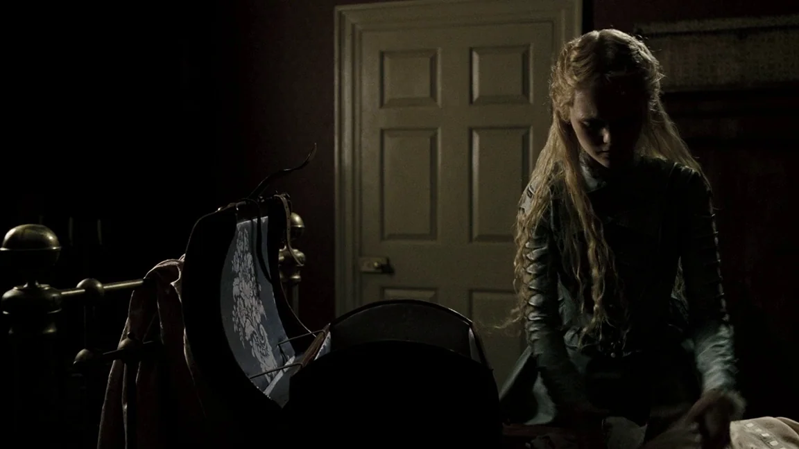 Sweeney Todd: The Demon Barber of Fleet Street (2007) movie still: medium — A dimly lit room contains a young woman near a large, opened antique…