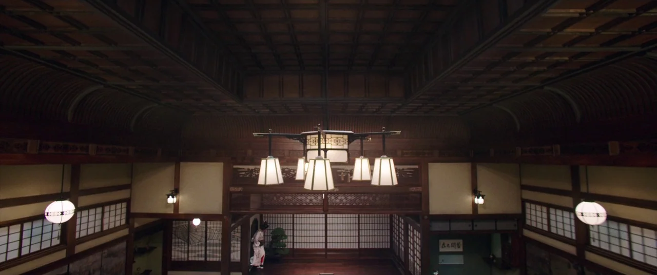 The Handmaiden (2016) movie still: establishing — A spacious traditional Japanese interior features dark coffered ceilings and sliding paper doors.…