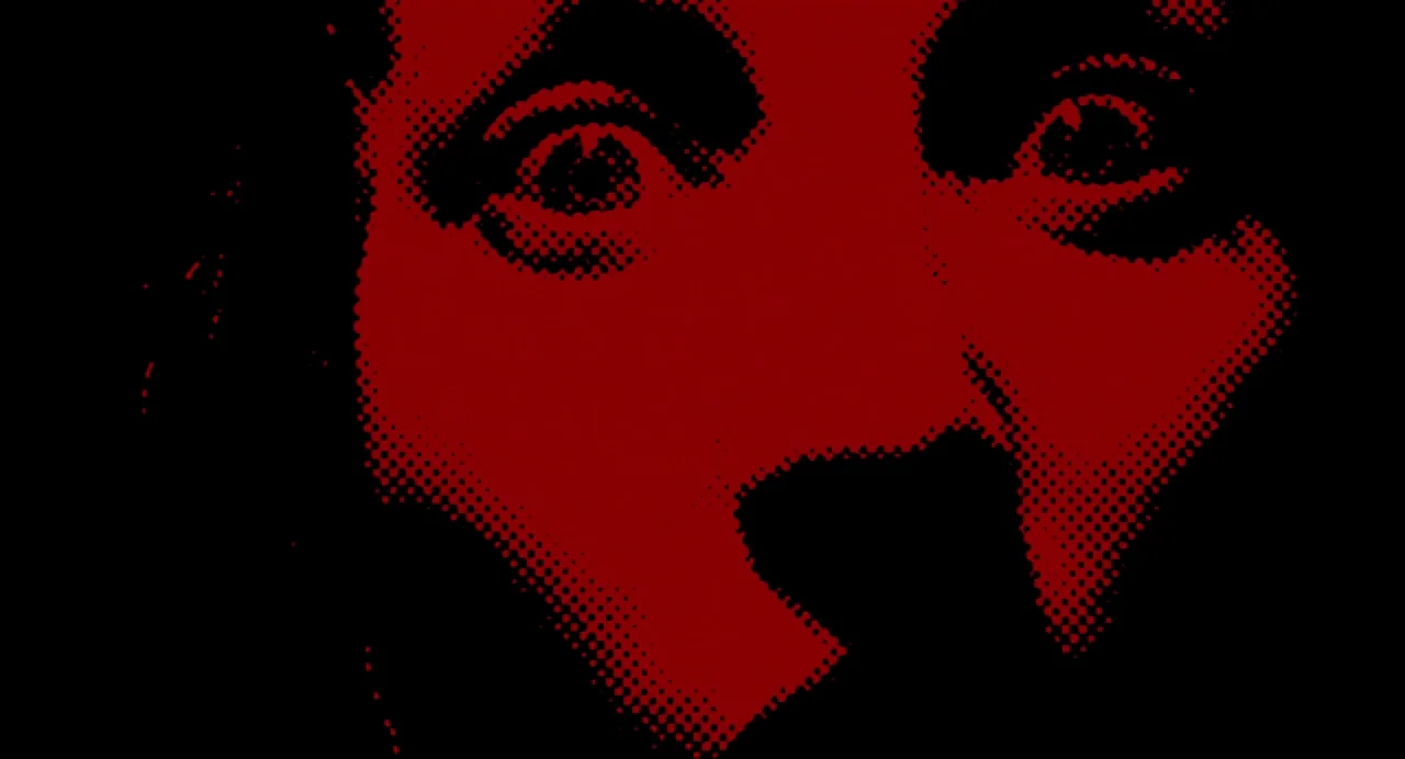 Berberian Sound Studio (2012) movie still: closeup — An abstract close-up image showing only eyes and nose bridge in red halftone. The dark areas…