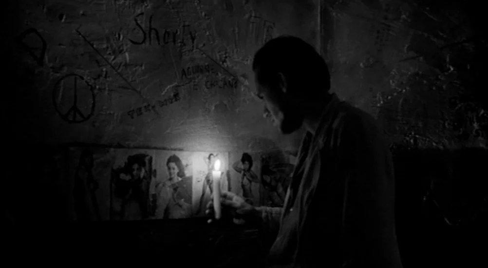 Kings of the Road (Im Lauf der Zeit) (1976) movie still: medium — A dark space with textured walls covered in graffiti and various small paper…