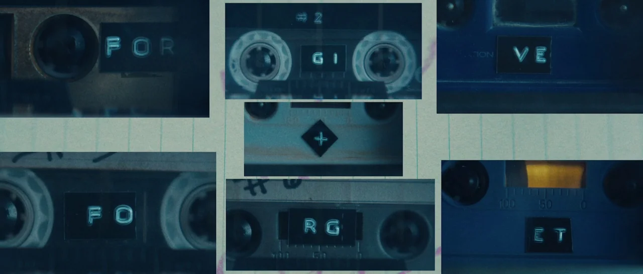 Starfish (2018) movie still: closeup — A composite grid displays multiple close-up shots of various vintage audio cassette tape labels. Each…