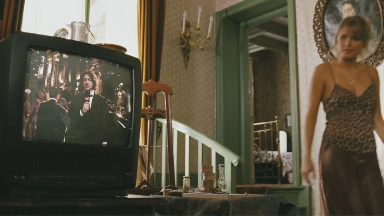 Deuce Bigalow: European Gigolo (2005) movie still: medium — A domestic interior features a vintage television set in the foreground displaying a…