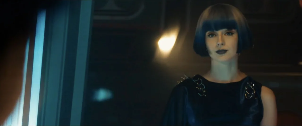 Star Trek: Section 31 (2025) movie still: medium — A dimly lit modern office space with dark walls and subtle ambient lighting. A woman with a blue…