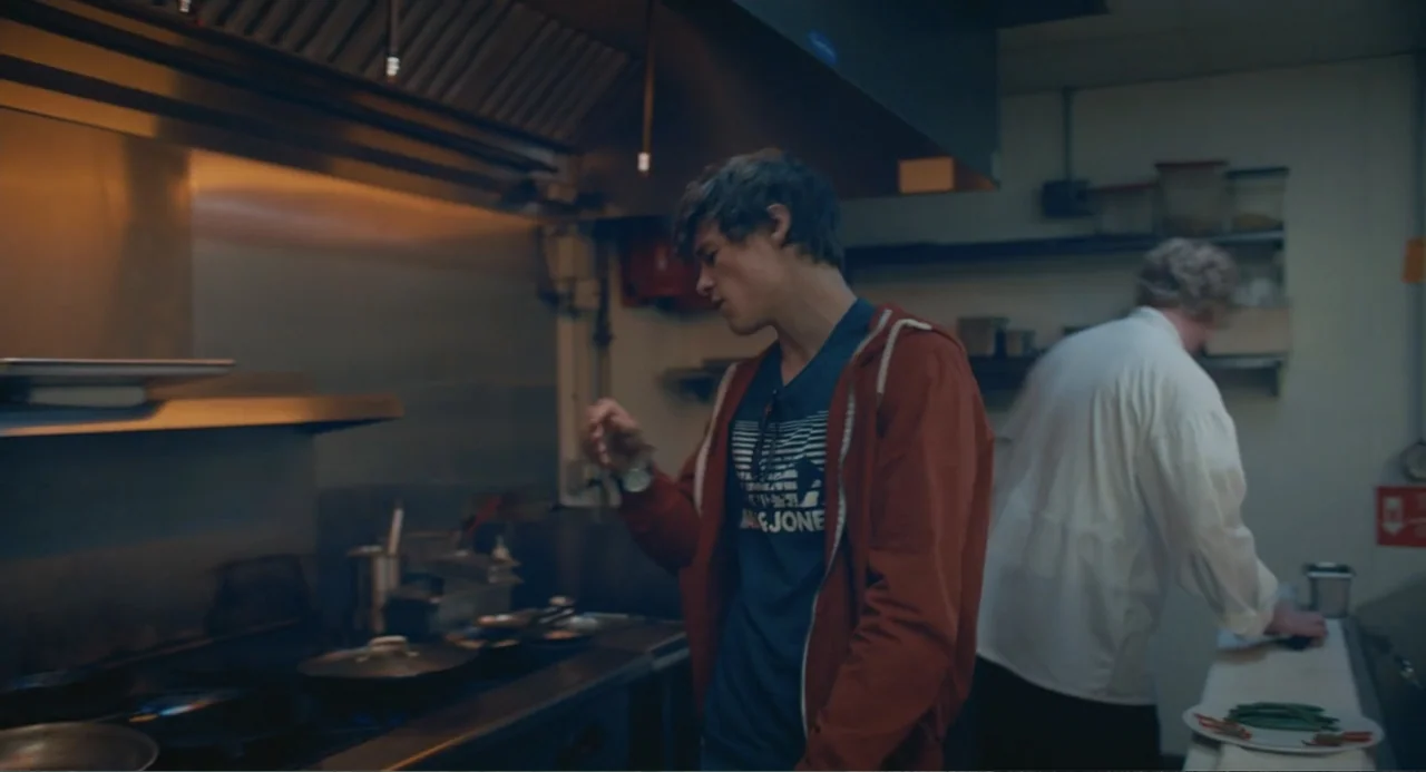 The Map of Tiny Perfect Things (2021) movie still: medium — A professional kitchen features stainless steel appliances and a counter with prepared…