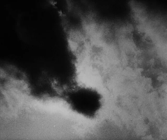 Vampyr (1932) movie still: establishing — A dense formation of dark, textured clouds fills the upper atmosphere. The swirling vapor formations move…