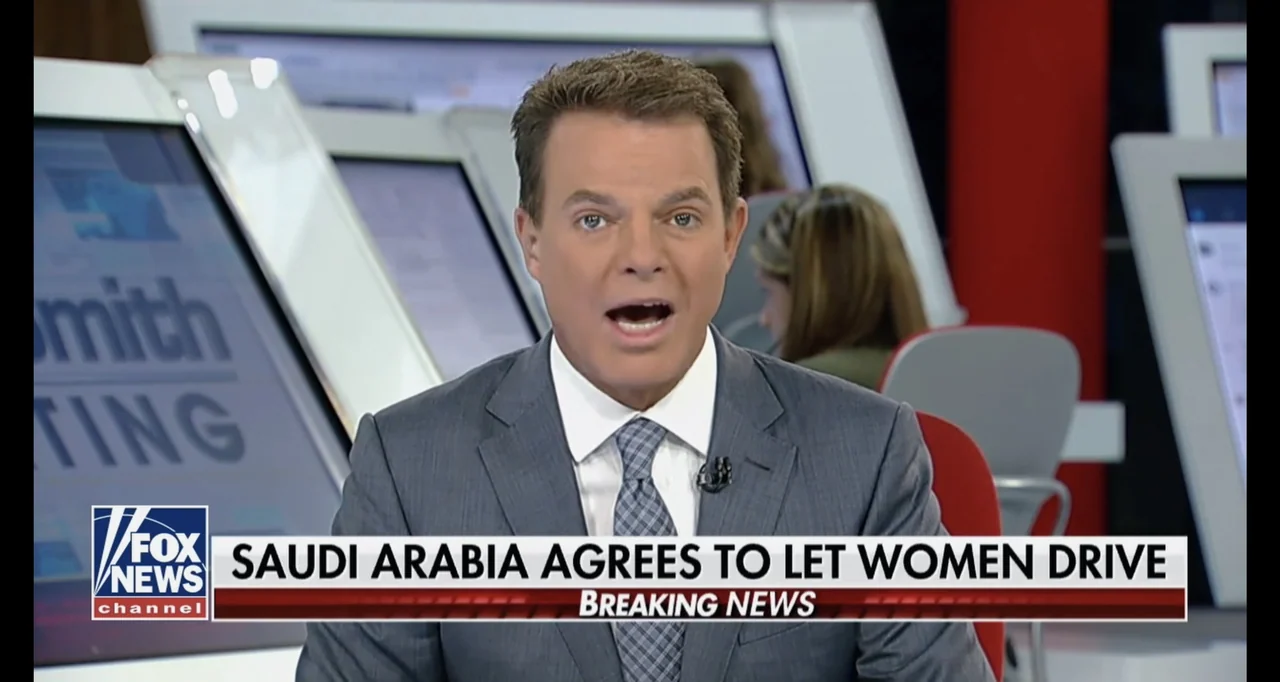 Saudi Women's Driving School (2019) movie still: medium — A modern television news studio set features illuminated displays and branding elements…