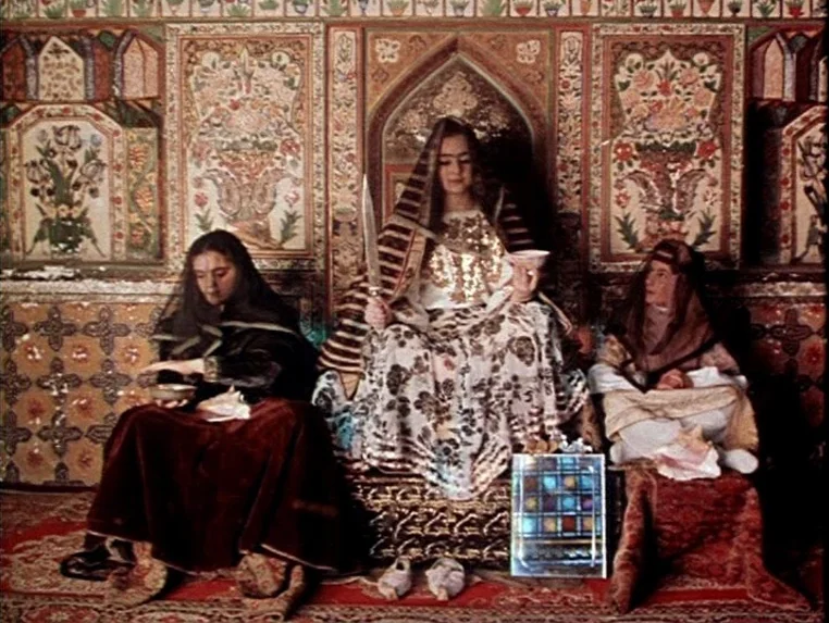 Ashik Kerib (1988) movie still: fullbody — A highly ornate interior space features walls covered in intricate floral fresco paintings. Three women…