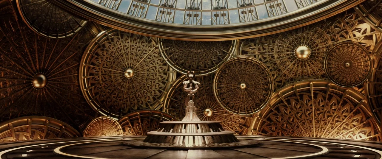 Thor: The Dark World (2013) movie still: wide — A vast circular room is decorated with oversized, intricate golden gears and rotating wheels. A…