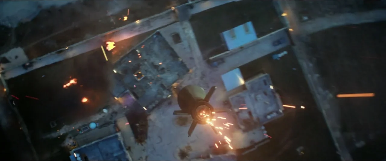 13 Hours: The Secret Soldiers of Benghazi (2016) movie still: wide — An overhead view shows a missile falling toward a burning compound at night.…