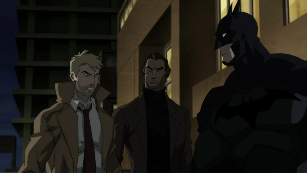 Justice League Dark (2017) movie still: medium — A night exterior urban setting features a tall dark building with illuminated yellow windows. Three…