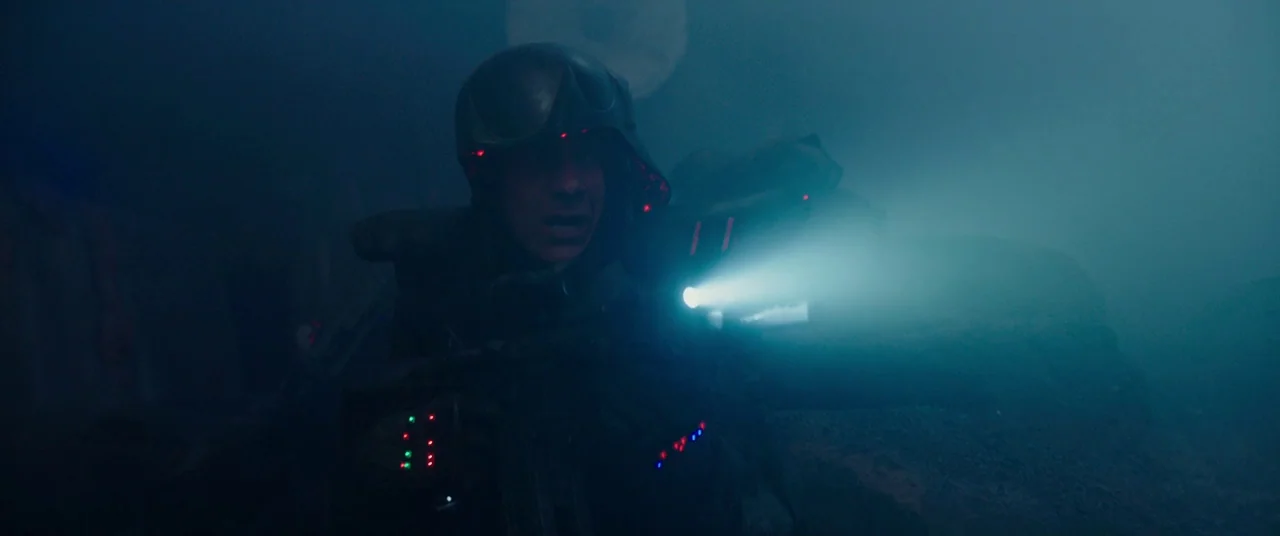 Valerian and the City of a Thousand Planets (2017) movie still: medium — A dark, fog-filled environment with limited visibility. A soldier in…