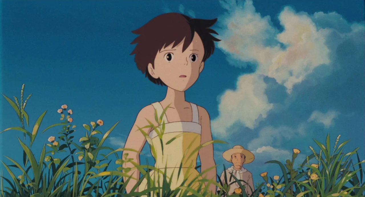 My Neighbour Totoro (1988) movie still: medium — A sunlit field with tall grass and wildflowers under a large blue sky. A young girl in a yellow…