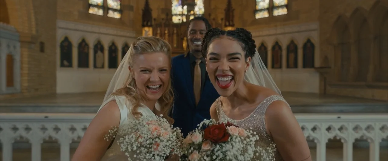 Anyone But You (2023) movie still: medium — A stone church interior features a central altar with arched architectural details and stained glass.…