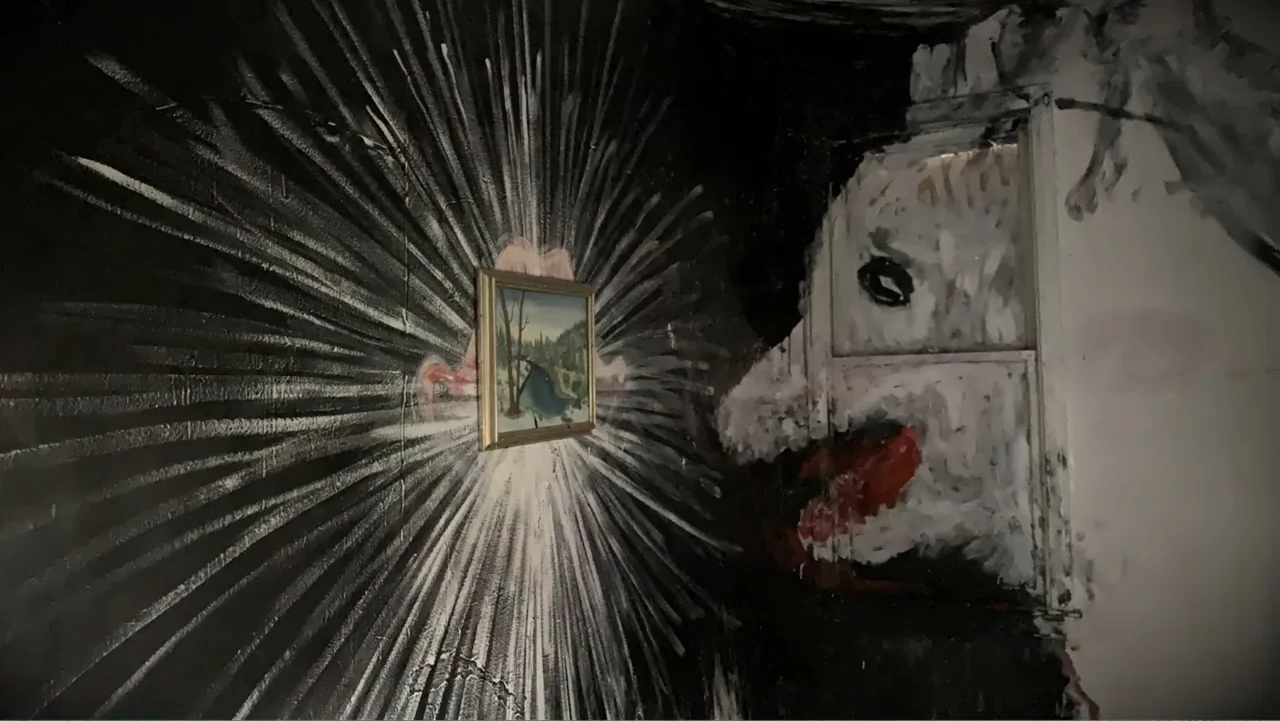 Inland Empire (2006) movie still: medium — A dark room features walls covered in expressive, high-contrast black and white painted murals. A small,…
