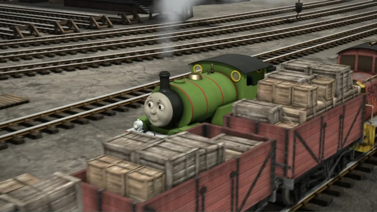 Thomas & Friends: Tale of the Brave (2014) movie still: medium — A green steam engine travels through a large industrial rail yard with multiple…