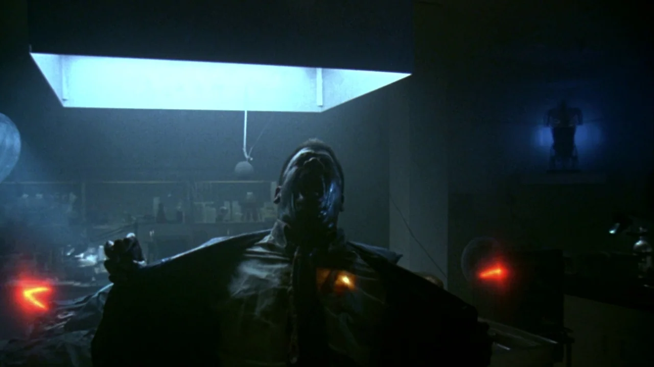 Jason Goes To Hell (1993) movie still: medium — A dark, industrial laboratory features an overhead lighting fixture and scattered electronic…