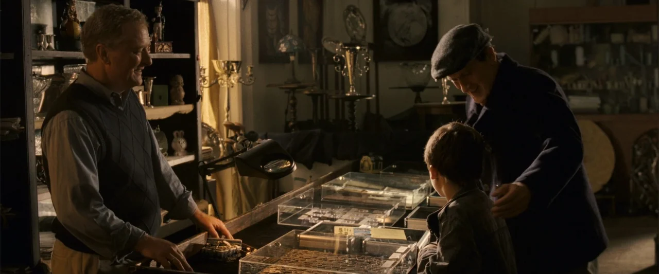 Dear John (2010) movie still: medium — An interior space filled with display cases and cluttered shelves of vintage artifacts. A shopkeeper…