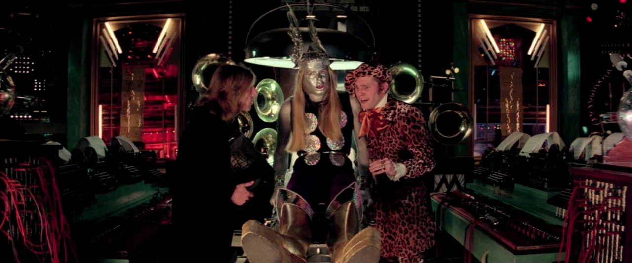 Lisztomania (1975) movie still: medium — A dark, complex recording studio filled with vintage electronics and industrial cables. Three figures stand…