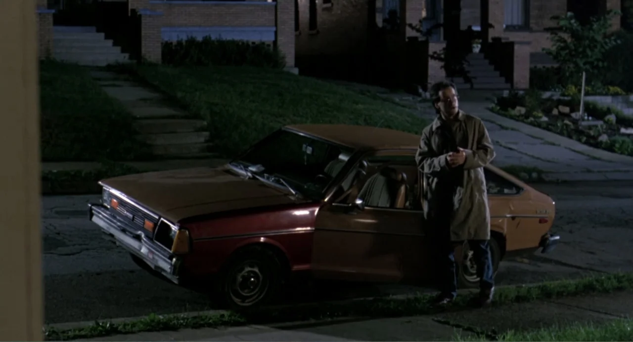 An Experiment in Fear: The Making of Monkey Shines (2014) movie still: medium — A residential suburban street at night features a two-tone sedan…
