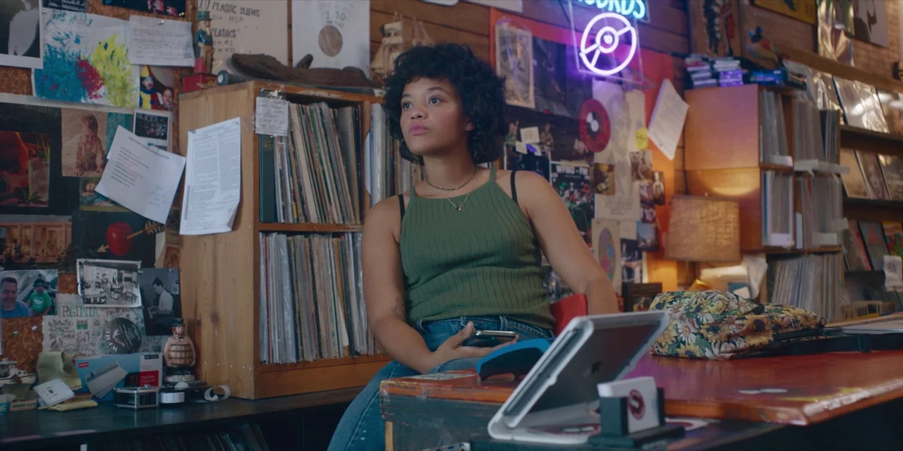 Hearts Beat Loud (2018) movie still: medium — A cluttered retail space features wooden shelves packed with vinyl records and assorted posters. A…
