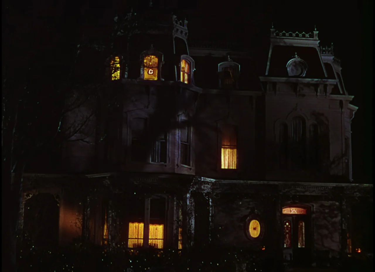 Meet Me In St. Louis (1944) movie still: establishing — A two-story Victorian mansion with a Mansard roof looms against a pitch black sky. Several…