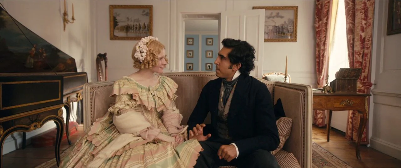 The Personal History of David Copperfield (2019) movie still: medium — A 19th-century interior with ornate furniture, wallpaper, and classic framed…