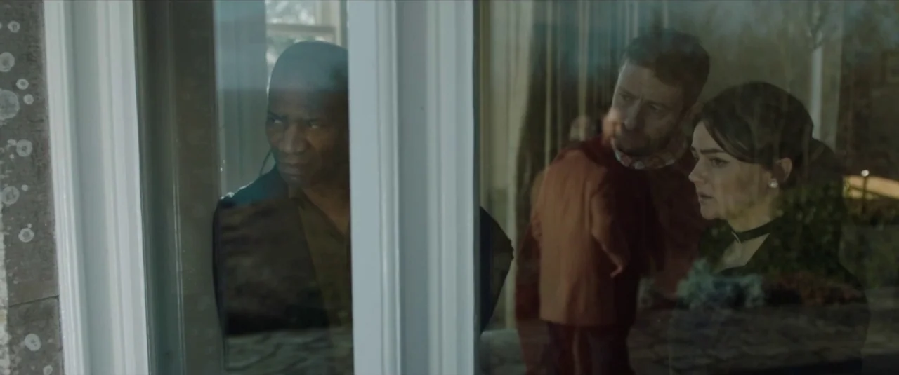 Happy New Year, Colin Burstead (2018) movie still: medium — Three people stand outside a building looking through a large pane of glass. Their…