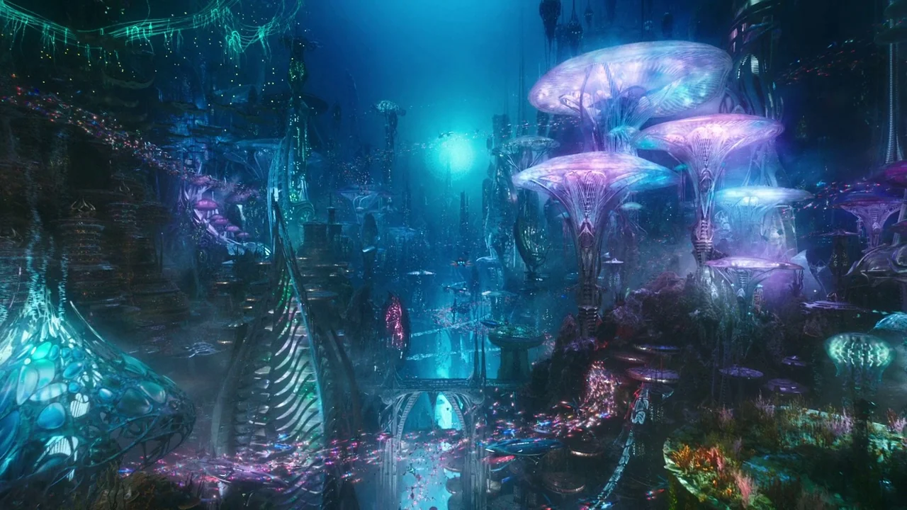 Aquaman (2018) movie still: establishing — A dense underwater city features tall, glowing, mushroom-shaped structures and intricate organic…