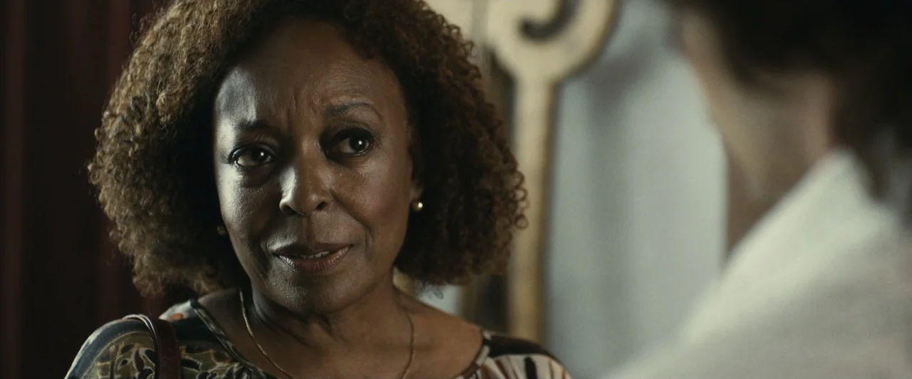 The Case for Christ (2017) movie still: closeup — An interior space features a woman in a patterned blouse against a neutral wall. The woman is…