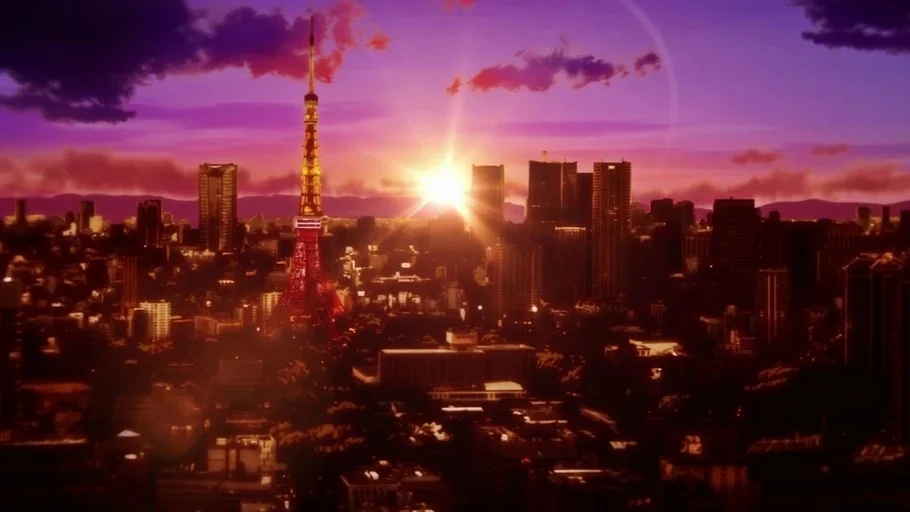 Jujutsu Kaisen (2020) movie still: establishing — An aerial view of a dense Japanese city at dusk featuring a prominent tower. The sun sets directly…