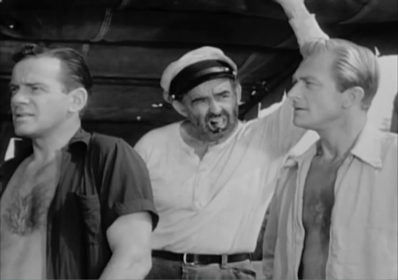 Creature from the Black Lagoon (1954) movie still: medium — A group of three men stand on the deck of a boat during the day. They are engaged in a…