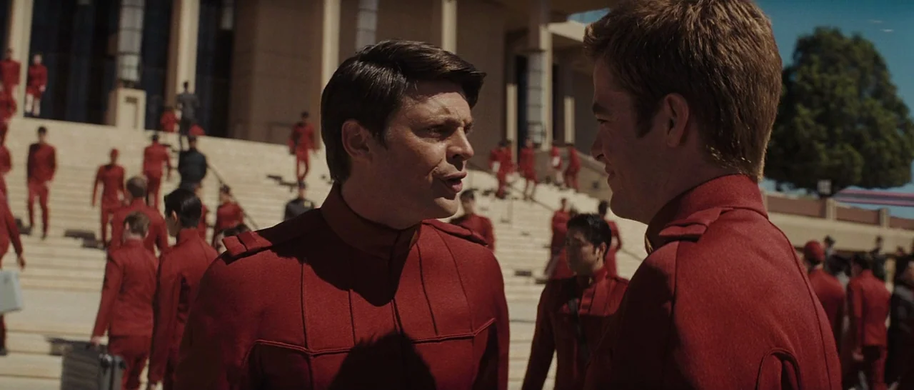 Star Trek (2009) movie still: medium — A grand outdoor stone staircase serves as the backdrop for a formal gathering. Numerous people in matching…