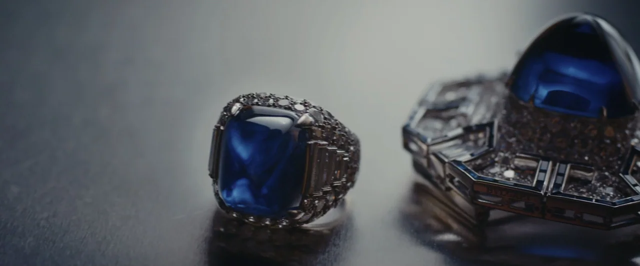 An emperor's jewel - The making of the Bulgari Hotel Roma (2024) movie still: closeup — A dark reflective surface displays two pieces of luxury…